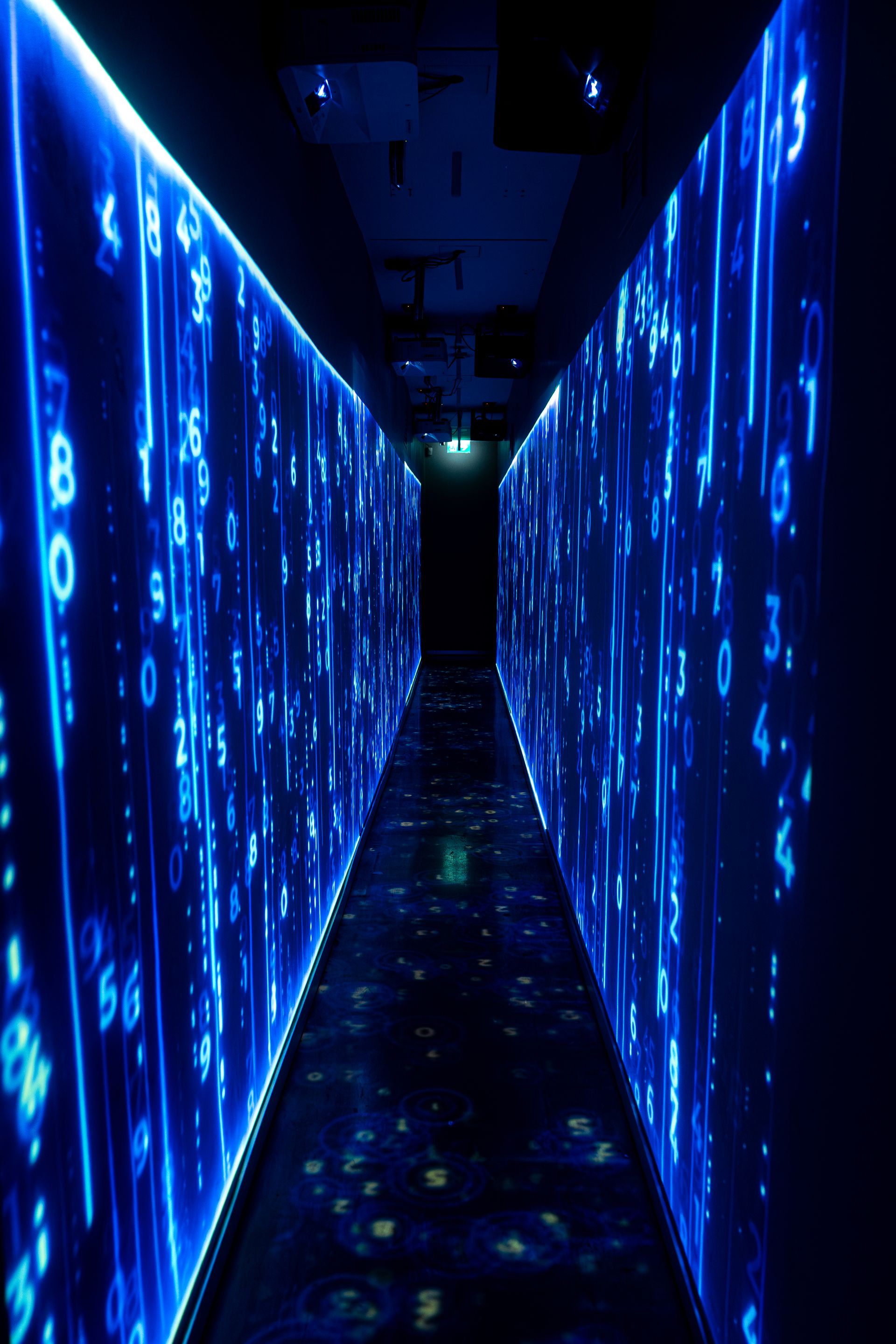 Immersive corridor illuminated with flowing blue digital data